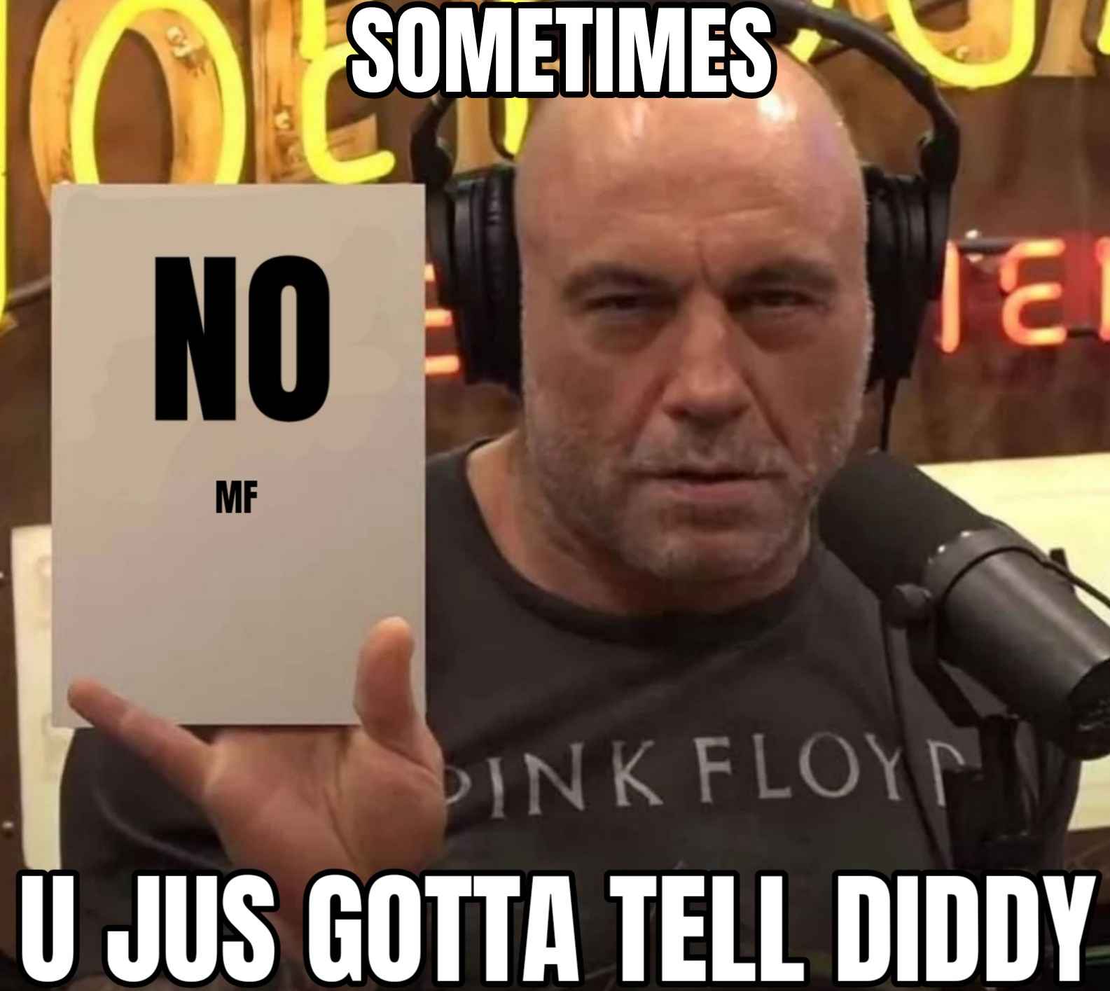 the text reads some times you gott tell diddy, and it's a picture of Joe Rogan squinting as if he is suspicious of something and he is holding up a sign that says no m f